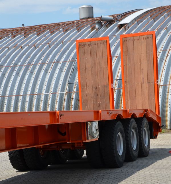 Hydraulically operated heavy duty rear loading ramps on lowbed trailer.