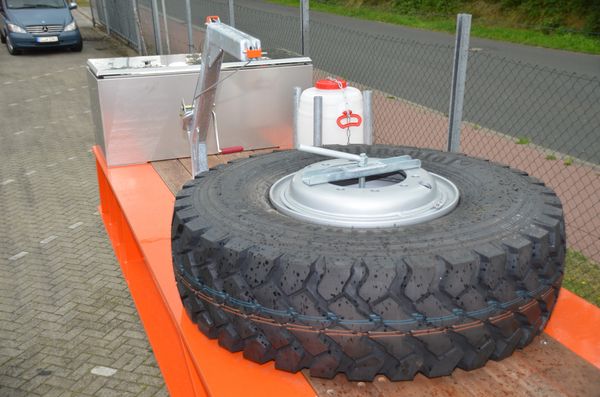 Spare wheel and hoist mounted on gooseneck of lowboy trailer